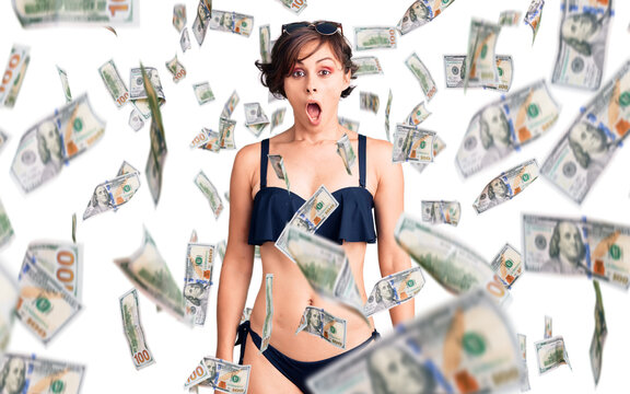 Beautiful young woman with short hair wearing bikini scared and amazed with open mouth for surprise, disbelief face