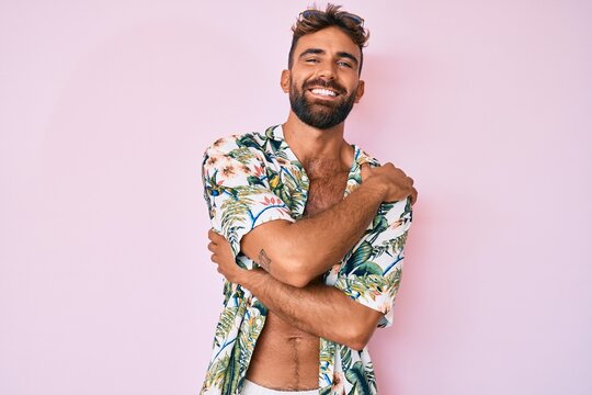 Young hispanic man wearing casual summer clothes scared and amazed with open mouth for surprise, disbelief face