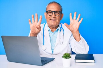 Senior handsome man with gray hair wearing doctor uniform working using computer laptop showing and pointing up with fingers number nine while smiling confident and happy.