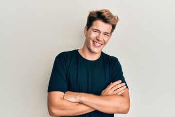 Handsome caucasian man wearing casual clothes happy face smiling with crossed arms looking at the camera. positive person.