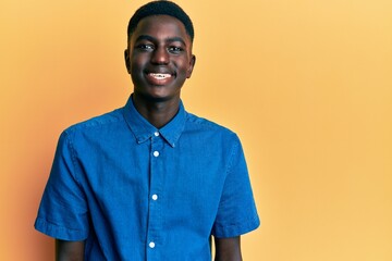 Obraz premium Young african american man wearing casual clothes with a happy and cool smile on face. lucky person.