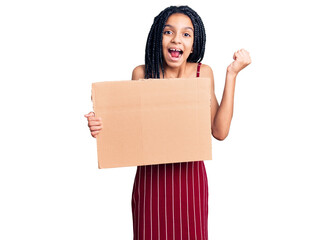 Cute african american girl holding empty banner screaming proud, celebrating victory and success very excited with raised arms