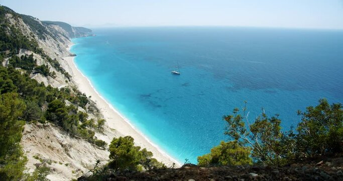 Luxury sail yacht boat in turquoise blue sea on Egremni beach, Lefkada island, Greece.