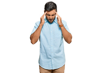 Fototapeta premium Handsome hispanic man wearing casual clothes with hand on head for pain in head because stress. suffering migraine.