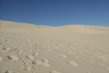 Fototapeta na wymiar Sand dunes and blue sky
