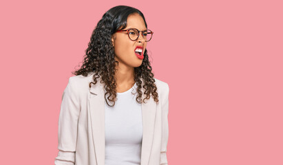 Young african american girl wearing business clothes angry and mad screaming frustrated and...