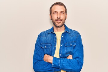 Young handsome man wearing casual clothes happy face smiling with crossed arms looking at the camera. positive person.