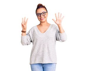 Young latin woman wearing casual clothes showing and pointing up with fingers number eight while smiling confident and happy.