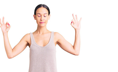 Fototapeta na wymiar Beautiful brunette young woman wearing casual dress relax and smiling with eyes closed doing meditation gesture with fingers. yoga concept.