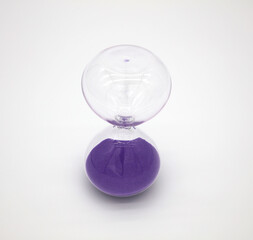 Glass hourglass on white background
