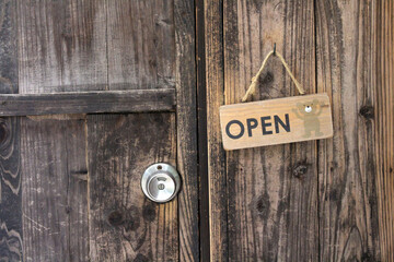 Japanese wooden door sign saying open.