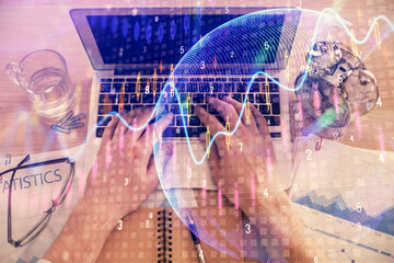 Double exposure of man's hands typing over laptop keyboard and forex chart hologram drawing. Top view. Financial markets concept.