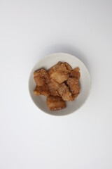 A bowl of steamed pork on a white background