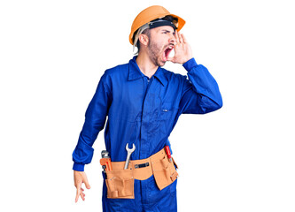 Young hispanic man wearing worker uniform shouting and screaming loud to side with hand on mouth. communication concept.