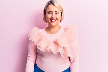 Obraz na płótnie Canvas Young beautiful blonde plus size woman wearing casual sweater over isolated pink background with a happy and cool smile on face. Lucky person.