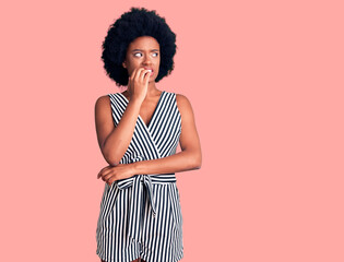 Young african american woman wearing casual clothes looking stressed and nervous with hands on mouth biting nails. anxiety problem.