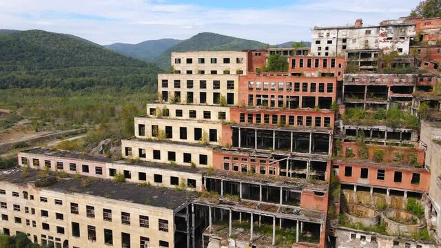 View from above. Khrustalnensky mining and processing plant. The camera flies past the destroyed buildings of a tin mining plant in Russia.