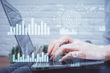 Multi exposure of woman hands typing on computer and forex chart hologram drawing. Stock market analysis concept.