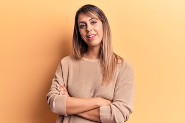 Fototapeta premium Young beautiful woman wearing casual sweater happy face smiling with crossed arms looking at the camera. positive person.