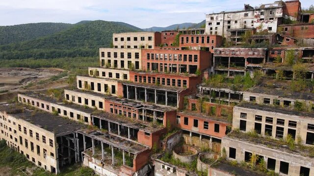 View from above. Khrustalnensky mining and processing plant. The camera flies past the destroyed buildings of a tin mining plant in Russia.