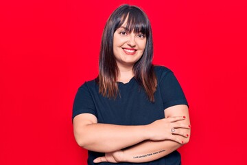 Young plus size woman wearing casual clothes happy face smiling with crossed arms looking at the camera. positive person.