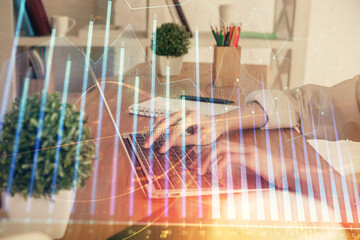 Double exposure of woman hands typing on computer and forex chart hologram drawing. Stock market invest concept.