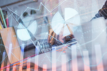 Double exposure of woman hands typing on computer and forex chart hologram drawing. Stock market invest concept.