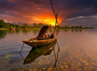 A small wooden boat in sunset.