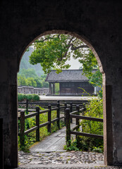 An oriental style bridge extended from a pavilion door