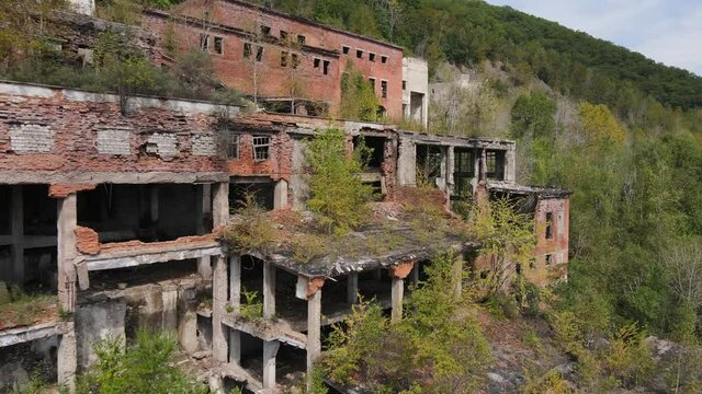 View from above. Khrustalnensky mining and processing plant. The camera flies past the destroyed buildings of a tin mining plant in Russia.