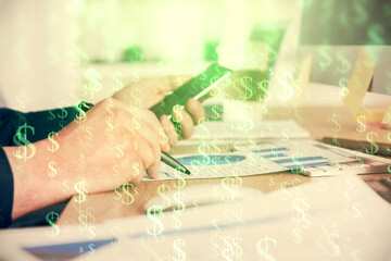 Obraz premium Double exposure of man's hands holding and using a phone and financial graph drawing. Analysis concept.