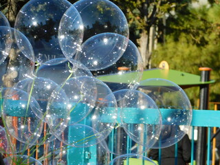 Naklejka premium Transparent balloons for kids near a playground