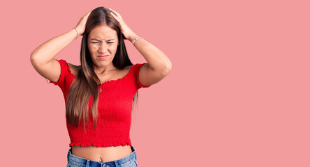 Young beautiful hispanic woman wearing casual clothes suffering from headache desperate and stressed because pain and migraine. hands on head.