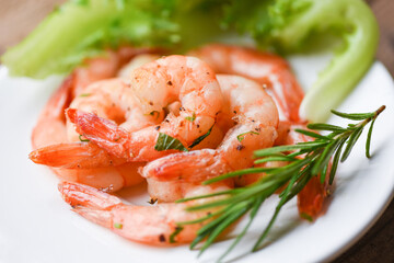 Appetizing cooked shrimps baked prawns , Seafood shelfish - Shrimp grilled delicious seasoning spices on white plate wooden background