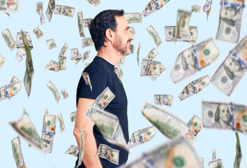 Middle age handsome man wearing casual t-shirt looking to side, relax profile pose with natural...