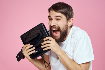 Man with prefix in hand joystick games lifestyle fun pink background white t-shirt