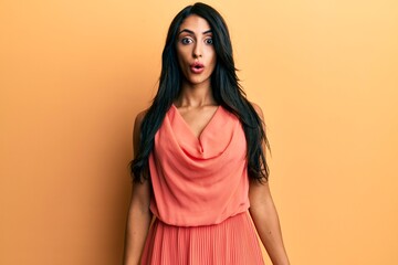 Obraz premium Beautiful hispanic woman wearing summer dress scared and amazed with open mouth for surprise, disbelief face