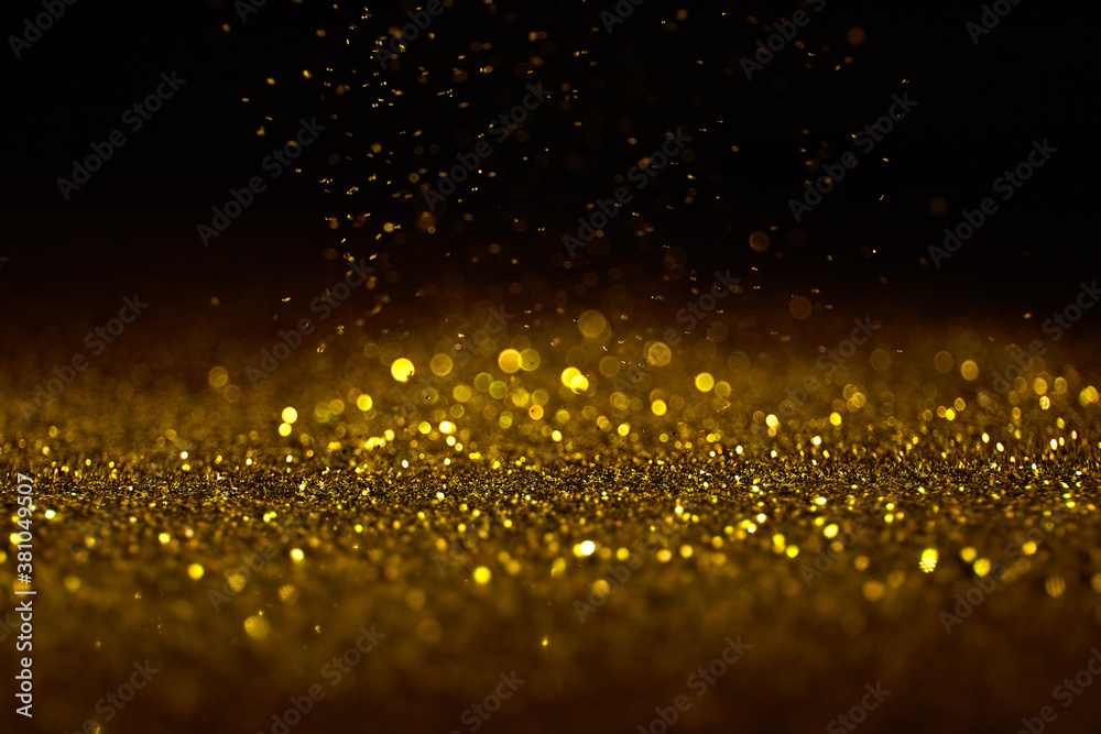 Wall mural sparkling golden glittering effect isolated on black background. - Wall murals
