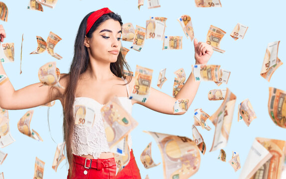 Brunette teenager girl wearing elegant look showing arms muscles smiling proud. fitness concept.