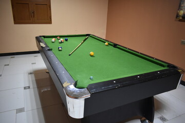 billiard table with cue and balls. Green billiards background