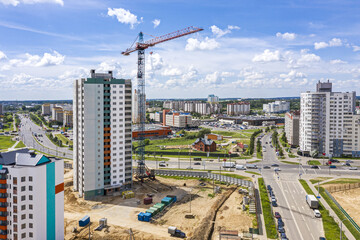 construction site with high-rise buildings and crane on blue sky background. aerial view