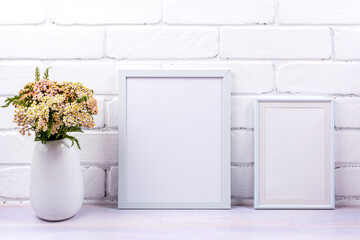 Two white poster frames mockup with pink yarrow
