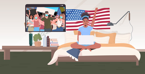 woman using laptop watching online video people in masks holding usa flags labor day celebration coronavirus quarantine self isolation concept living room interior full length horizontal vector