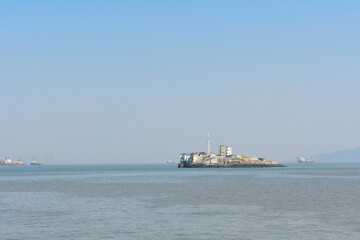 A small little island in the middle of the blue ocean