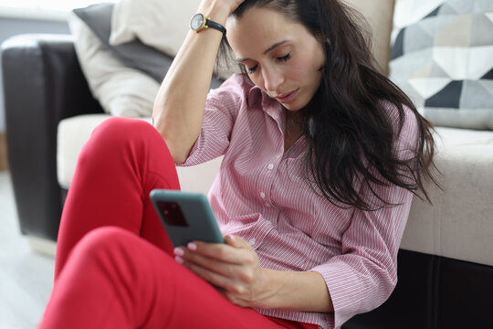 Depressed woman sits with closed eyes and holds smartphone in her hands. Stressful situations in women's life concept - Powered by Adobe