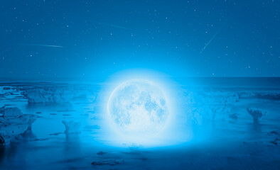 Full moon in the sea, falling star in the background "Elements of this image furnished by NASA
