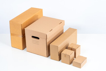 Carton boxes. Unlabeled boxes on a white background. Concept - sale of corton containers. Packaging materials store. Wholesale of cardboard boxes. Parcels packing box. Packaging for transportation