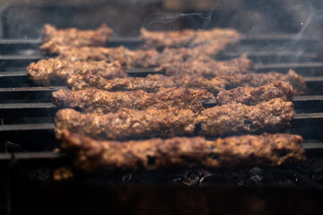 Sheekh Kabab being cooked over a charcoal grill