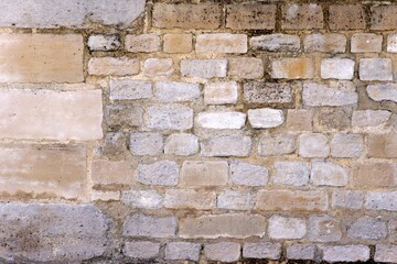 A view of an ancient or a very old wall of rural area made up of different sizes of bricks and also diverse in colors