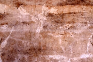 A very old brown colored wall with scratches over it